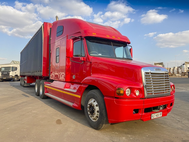 Used 2000 Freightliner Century Class 120 6x4 RHD Truck Tractor and 2011 Henred Fruehauf Tautliner Tri-axle Trailer Combo for sale.